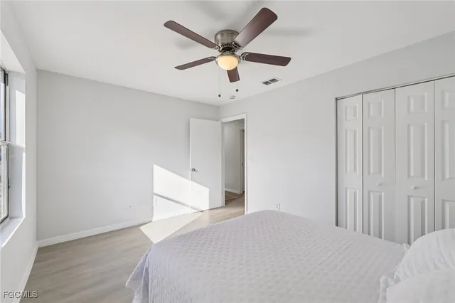 a bed room with a bed and a ceiling fan