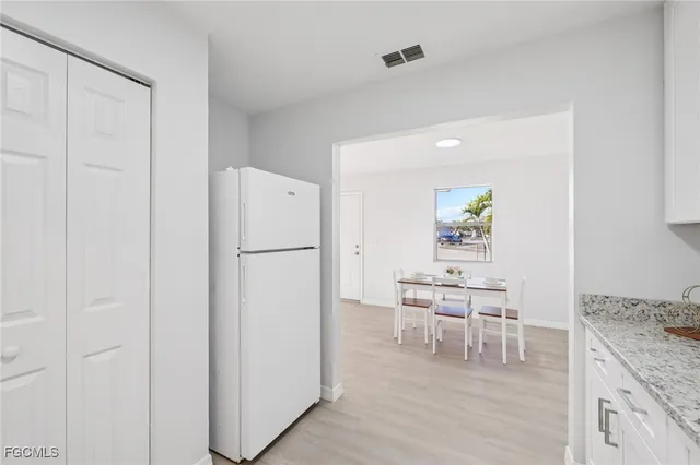 a kitchen with stainless steel appliances granite countertop a refrigerator and a stove top oven