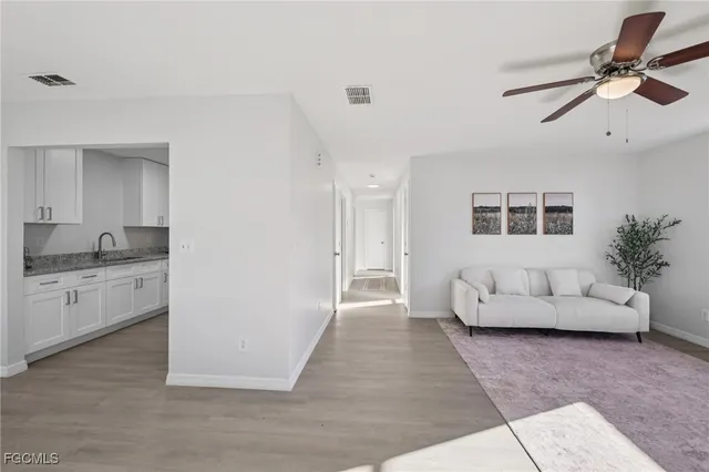 a living room with furniture and white walls