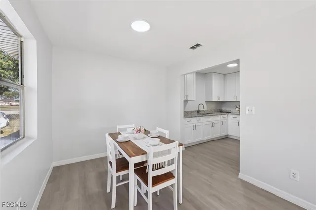 a kitchen with a table and chairs in it