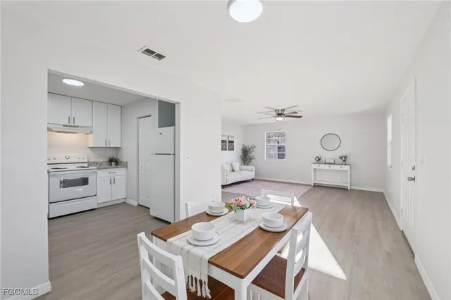 a open kitchen with white cabinets and stainless steel appliances