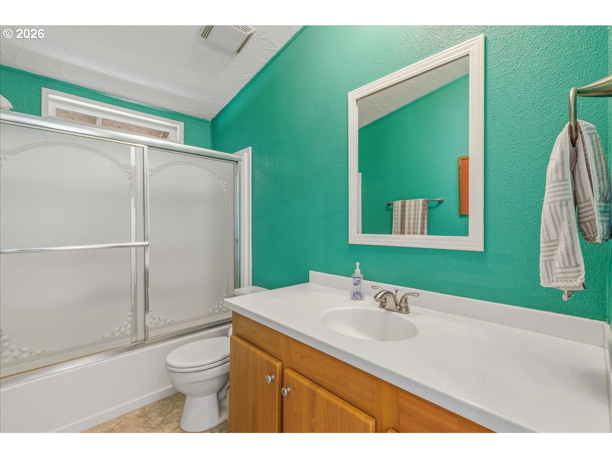 475 East 9th Street Rainier, OR 97048 - Photo 21 of 43 a bathroom with a sink a toilet and a mirror