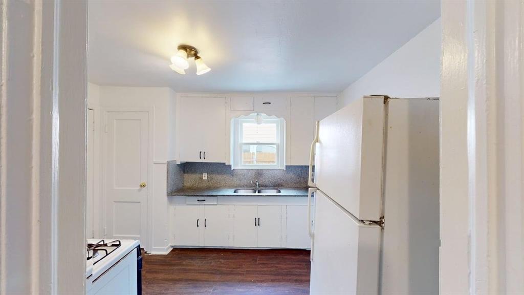 2246 Anson Road Dallas, TX 75235 - Photo 5 of 20 a kitchen with stainless steel appliances granite countertop a refrigerator and a stove