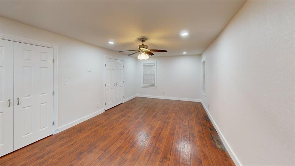 2246 Anson Road Dallas, TX 75235 - Photo 9 of 20 wooden floor in an empty room with a window