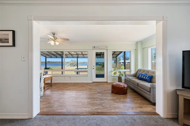 a living room with patio furniture and a floor to ceiling window