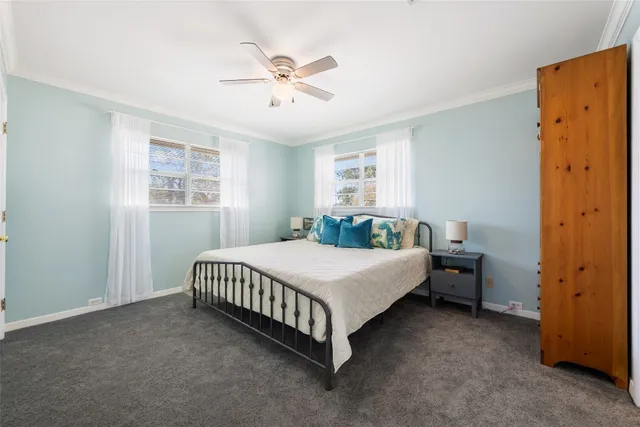 a view of an empty room with wooden floor and closet