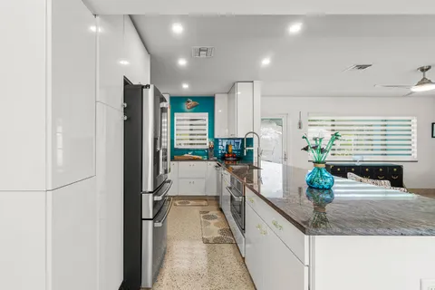 a kitchen with stainless steel appliances granite countertop a stove and a refrigerator