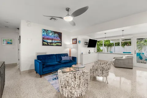 a living room with a bed and a dresser