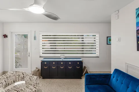 a living room with couch and a window