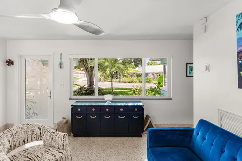 a bedroom with a large bed and a wooden floor