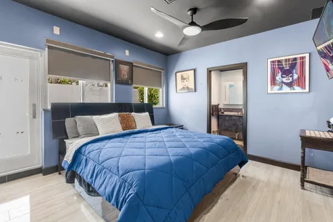 a large bedroom with a bed and a large window