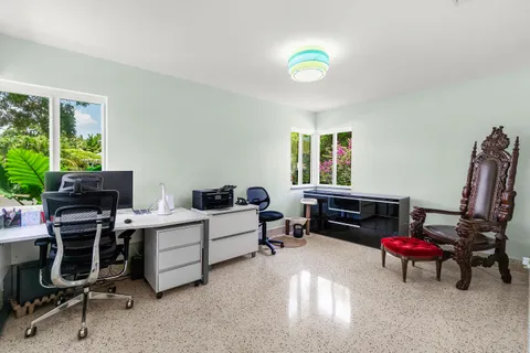 a bedroom with a bed and painting on the wall