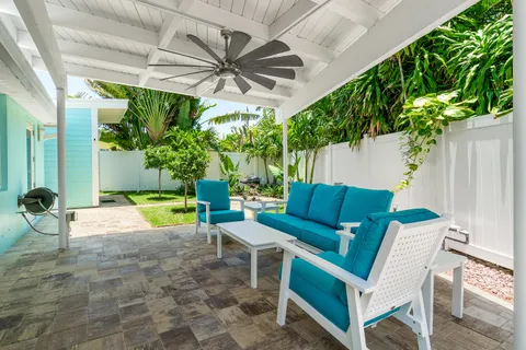 a view of a patio with table and chairs potted plants with wooden floor