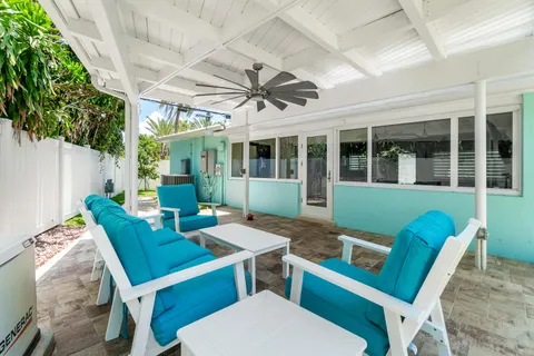 a backyard of a house with plants and large trees