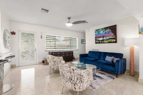 a kitchen with stainless steel appliances kitchen island granite countertop a refrigerator a stove a sink dishwasher with a dining table and chairs