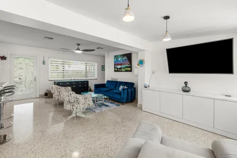 a living room with lots of furniture and view of kitchen