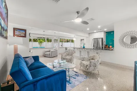 a kitchen with furniture and a flat screen tv
