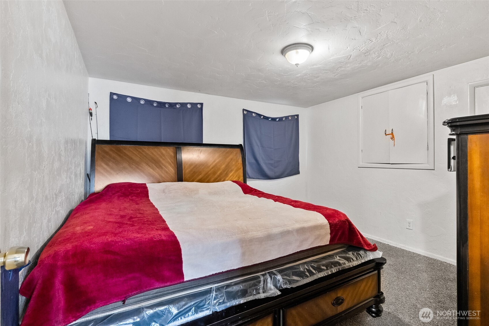 1304 West Hopkins Street Pasco, WA 99301 - Photo 10 of 12 a bed sitting in a bedroom next to a window