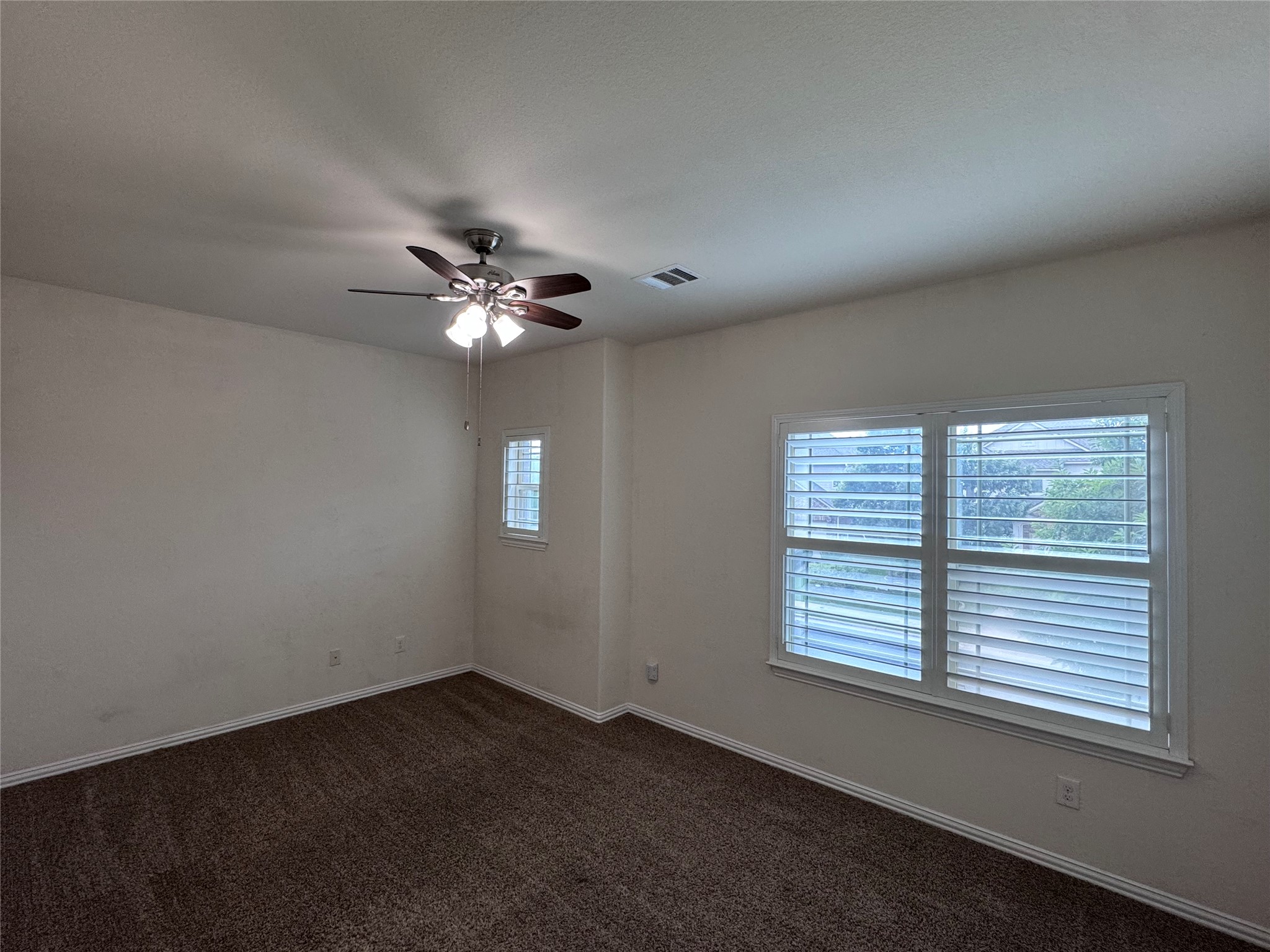 2605 Rough Berry Road Pflugerville, TX 78660 - Photo 22 of 40 A restful primary bedroom retreat with soft carpeting and ample natural light.