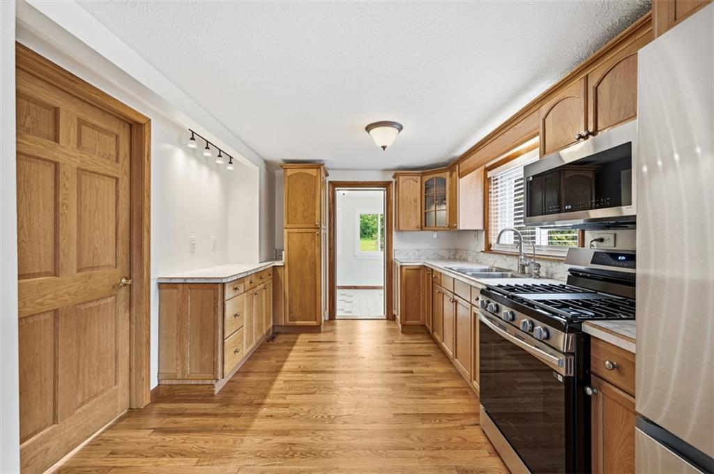 123 Cemetery Road Slippery Rock, PA 16057 - Photo 10 of 33 The kitchen combines warmth and functionality with hardwood floors, abundant cabinetry, and new stainless steel appliances. Generous counter space and an efficient layout make meal preparation and entertaining a breeze.