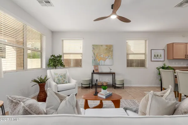 a living room with furniture kitchen and a window