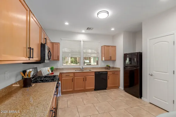 a kitchen with a sink a stove and cabinets
