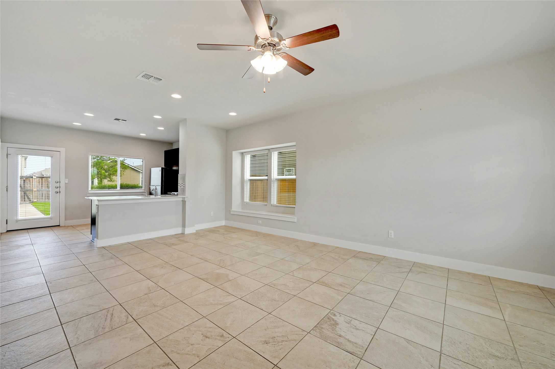 121 Switchgrass Street San Marcos, TX 78666 - Photo 7 of 33 Spacious living room opens up to the kitchen.