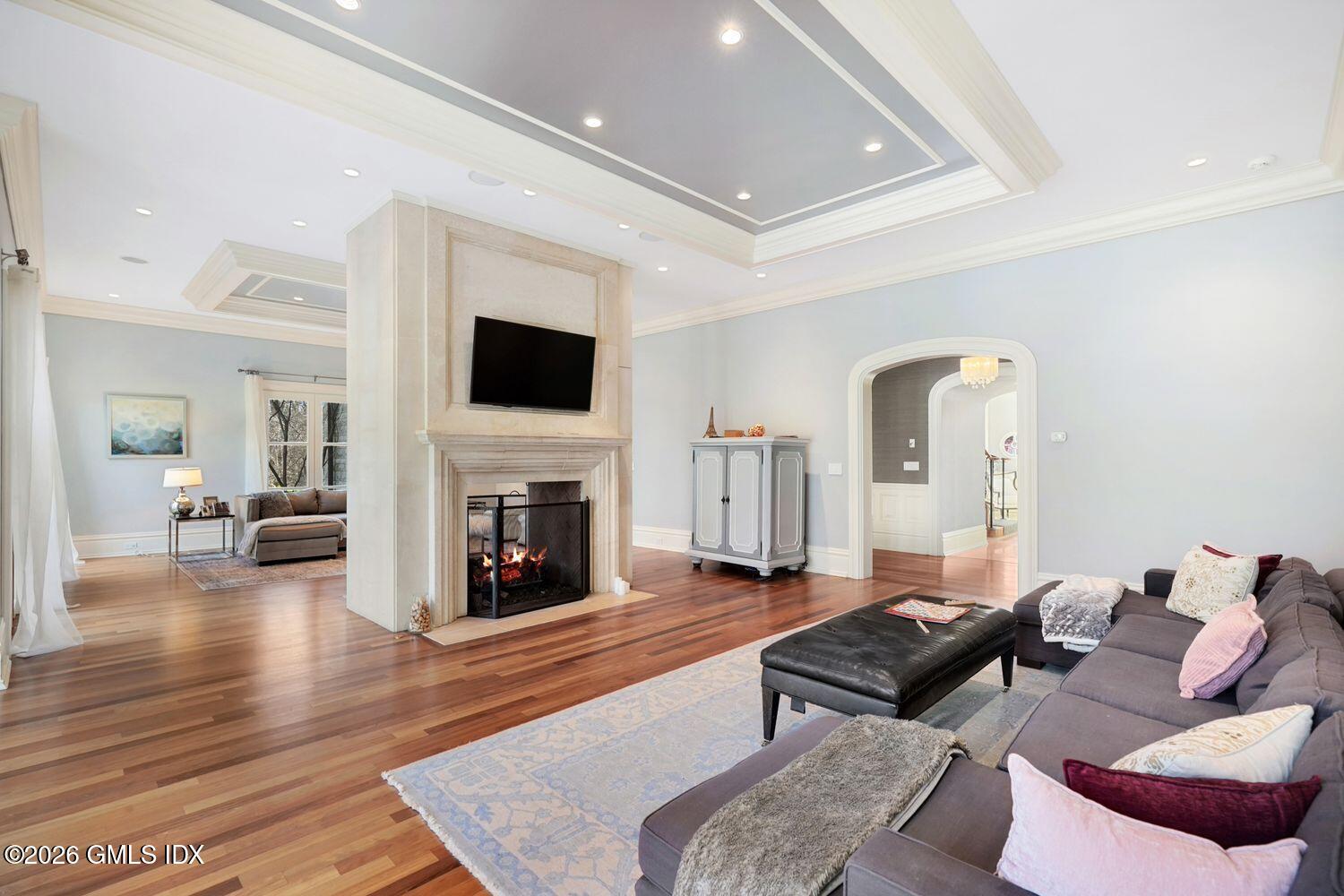 44 Hunting Ridge Road Greenwich, CT 06831 - Photo 11 of 30 a living room with furniture a fireplace and a flat screen tv