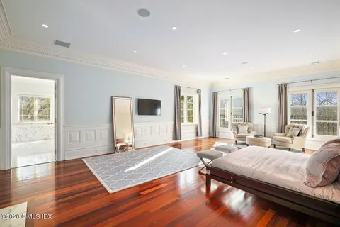 a bedroom with a large bed and a large window