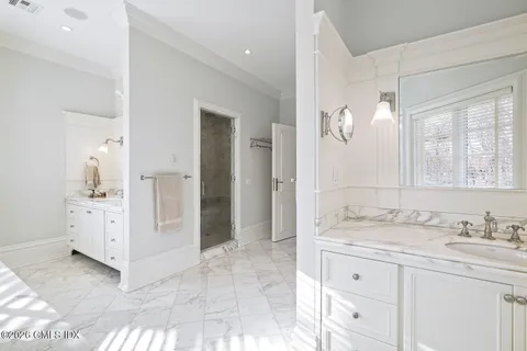 a spacious bathroom with a granite countertop sink mirror and
