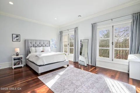 a spacious bedroom with a bed and a large window