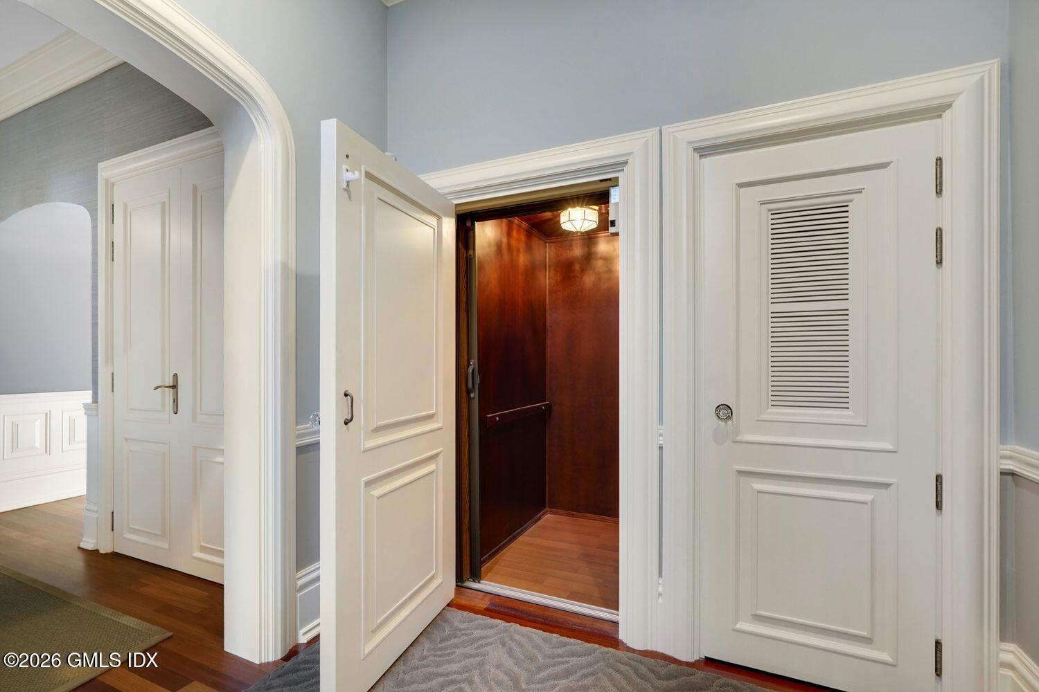 44 Hunting Ridge Road Greenwich, CT 06831 - Photo 23 of 30 a view of a hallway with wooden floor and cabinet