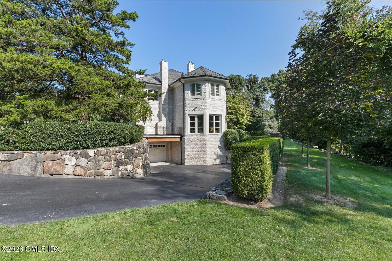 44 Hunting Ridge Road Greenwich, CT 06831 - Photo 26 of 30 a view of a house with a yard and sitting area
