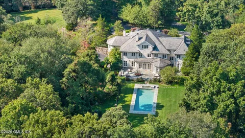 an aerial view of a house with a yard