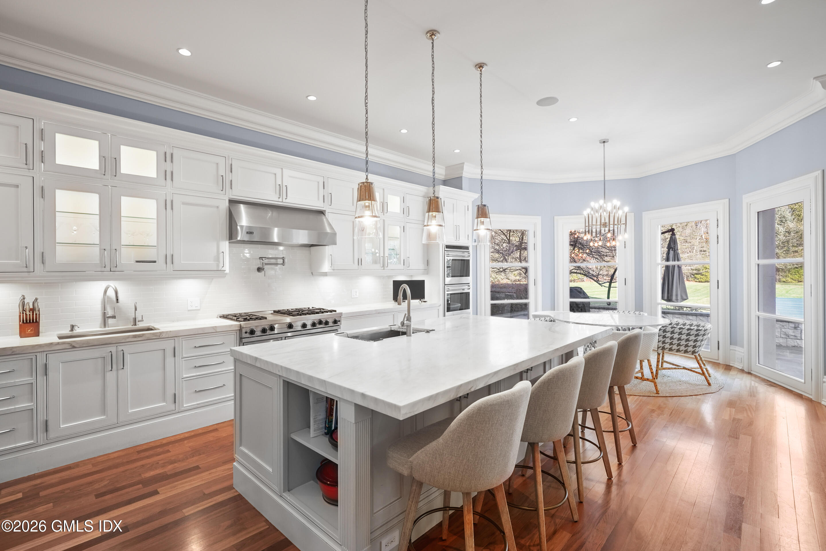 44 Hunting Ridge Road Greenwich, CT 06831 - Photo 6 of 30 a large kitchen with stainless steel appliances a stove a sink a center island and windows