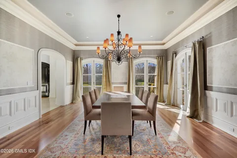 a view of a dining room with furniture wooden floor and chandelier