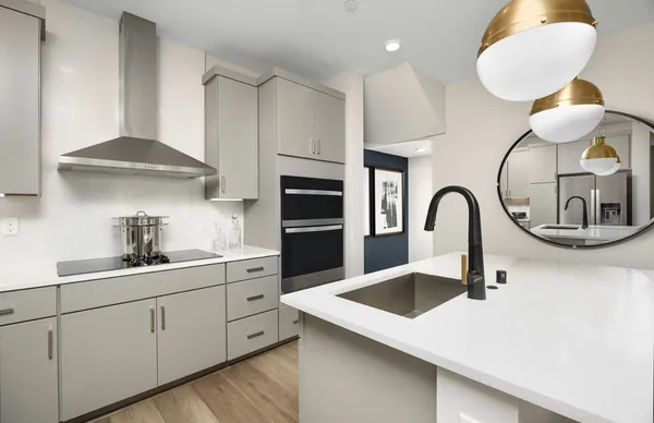 a kitchen with white cabinets a sink and dishwasher