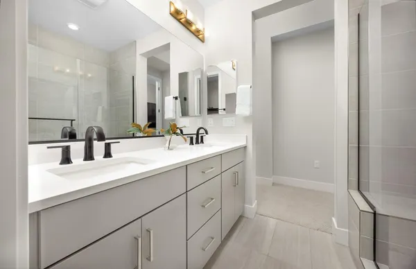 a bathroom with a double vanity sink and mirror