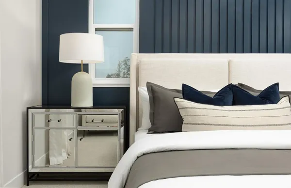 a bedroom with a bed and a lamp