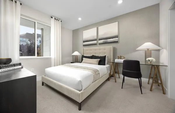 a bedroom with a bed and a lamp