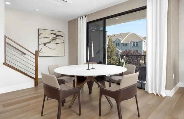 a view of a table and chairs in wooden floor