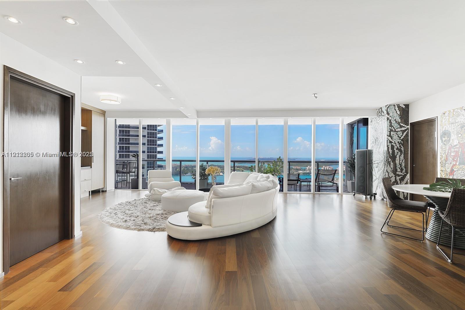 450 Alton Road, Unit 3303 Miami Beach, FL 33139 - Photo 16 of 35 a living room with furniture and a flat screen tv