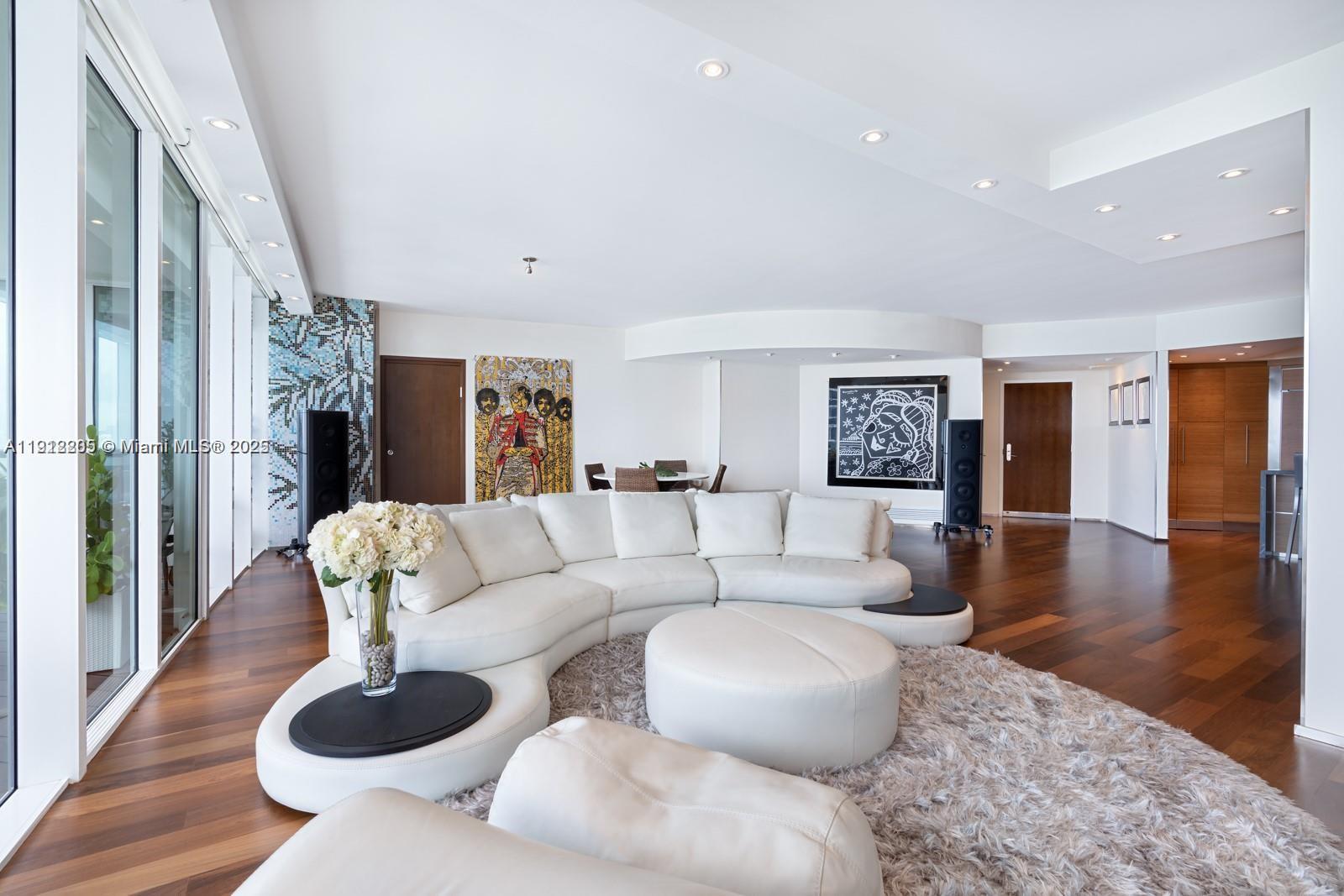 450 Alton Road, Unit 3303 Miami Beach, FL 33139 - Photo 2 of 35 a living room with furniture and wooden floor
