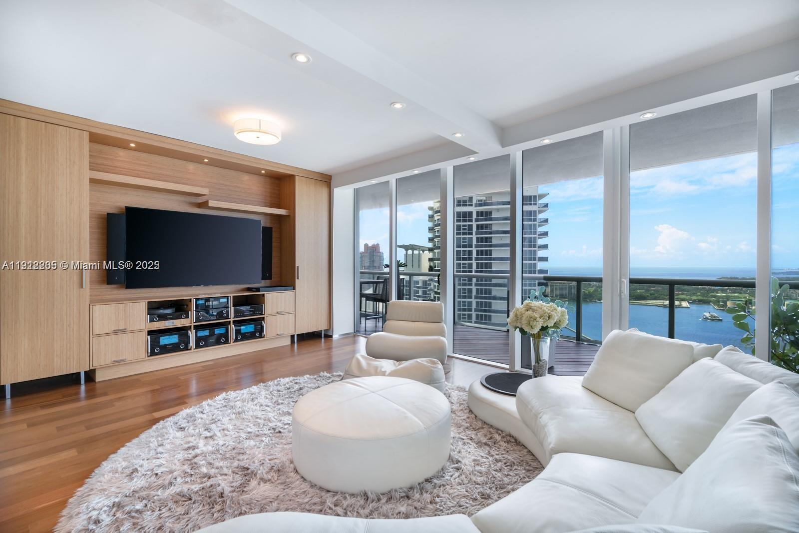 450 Alton Road, Unit 3303 Miami Beach, FL 33139 - Photo 4 of 35 a living room with furniture and a flat screen tv
