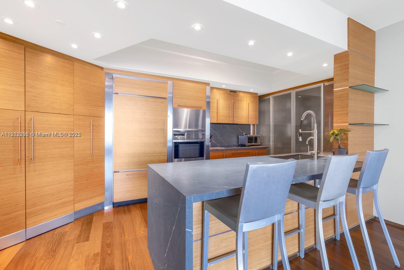 450 Alton Road, Unit 3303 Miami Beach, FL 33139 - Photo 6 of 35 a view of kitchen and dining area with furniture