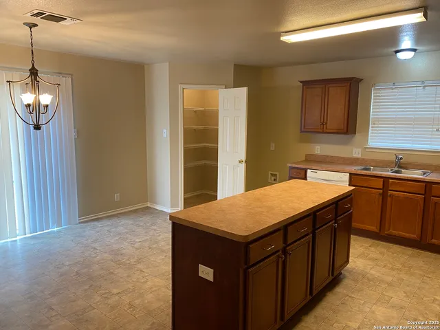 a kitchen with a sink stove and microwave