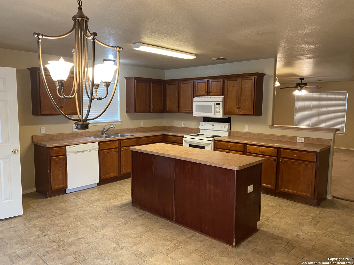 3338 Whisper Manor Schertz, TX 78108 - Photo 12 of 45 a kitchen with a sink stove and microwave