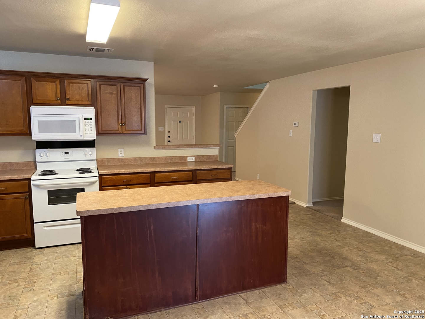3338 Whisper Manor Schertz, TX 78108 - Photo 13 of 45 a kitchen with stainless steel appliances a stove a microwave a sink and cabinets