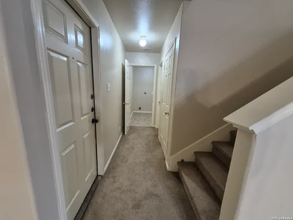 a view of a hallway with a white walls