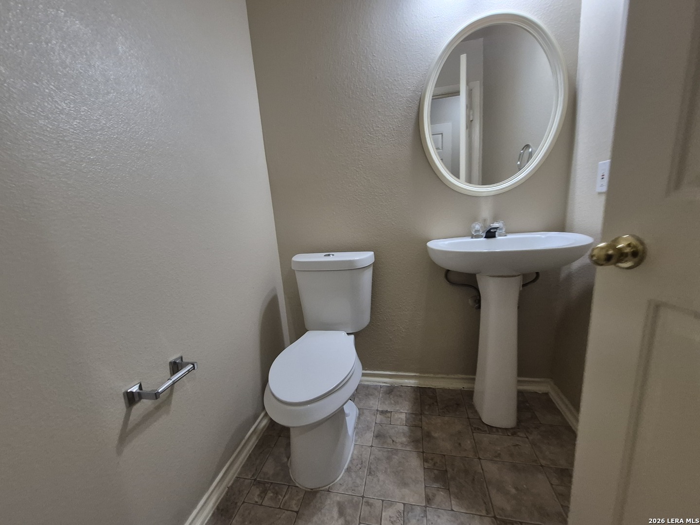 3338 Whisper Manor Schertz, TX 78108 - Photo 18 of 40 a bathroom with a toilet sink and mirror